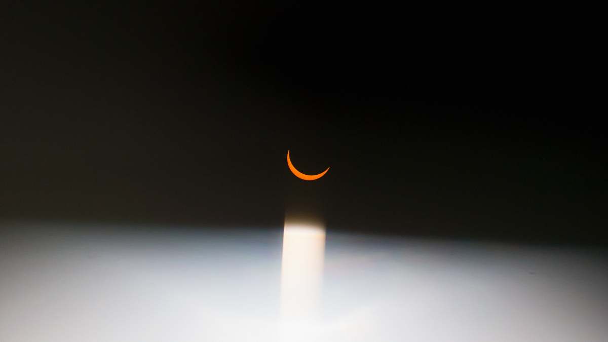 palm coast A red crescent moon surrounded by darkness. black